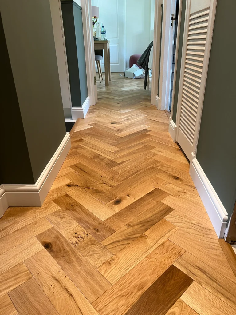 Long herringbone floor hallway installation – Central London