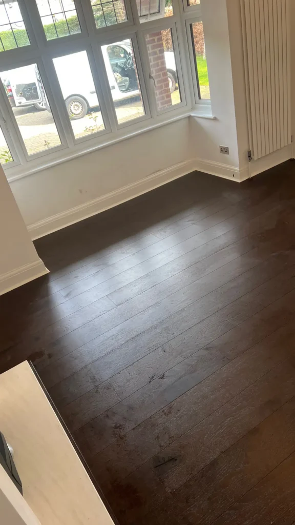 Dark wood flooring installation in bright North London living room