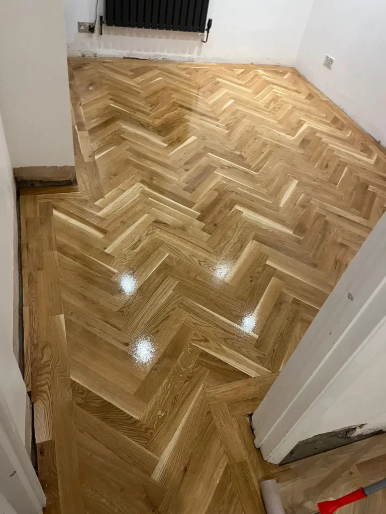 Newly installed and polished herringbone floor in residential London home